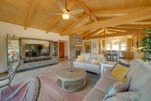 a living room with a couch and a table at Inviting Manchester Home with Hot Tub Near Beach! in Manchester