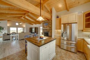 a large kitchen with wooden ceilings and wooden counters at Inviting Manchester Home with Hot Tub Near Beach! in Manchester