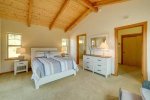 a bedroom with a bed and a dresser and a mirror at Inviting Manchester Home with Hot Tub Near Beach! in Manchester