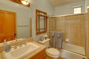 a bathroom with a sink and a toilet and a shower at Inviting Manchester Home with Hot Tub Near Beach! in Manchester +29 photos