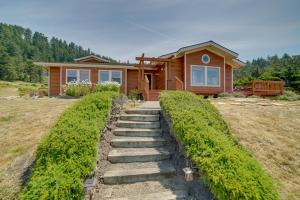 a home with a staircase leading to a house at Inviting Manchester Home with Hot Tub Near Beach! in Manchester