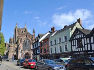 a city street with cars parked in front of a church at The Annexe in Hereford