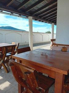 drewniany stół i krzesła na patio w obiekcie Gura Raului Casa de Vacanta w mieście Gura Râului