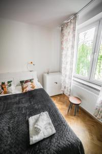 a bedroom with a large bed and a window at Vistula River Modern Apartment in Krakow