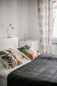 a bedroom with a bed with two pillows on it at Vistula River Modern Apartment in Krakow