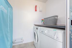 a laundry room with a washer and dryer at The Bay in Culnacnoc