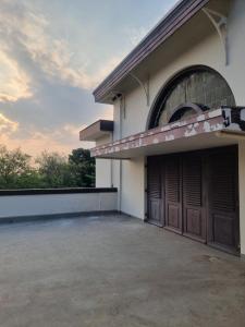 a building with two garage doors on the side at Hotel Candi Baru in Jomblang