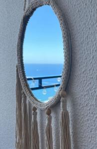 a mirror with a window with a view of the ocean at Stunning sunset ocean view apt. in Taurito