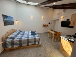 a bedroom with a bed and a kitchen with a table at Casa del Caffè Boutique in Trieste
