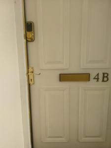 a white door with the number on it at Alberto's in Broxburn