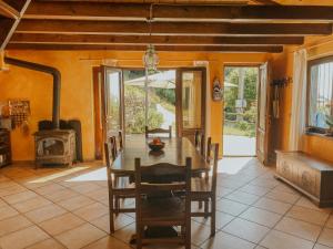 a dining room with a table and a fireplace at Ca’ Ai Monti in Trarego +24 photos