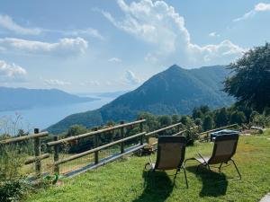 dwa krzesła siedzące na szczycie wzgórza z widokiem w obiekcie Ca’ Ai Monti w mieście Trarego
