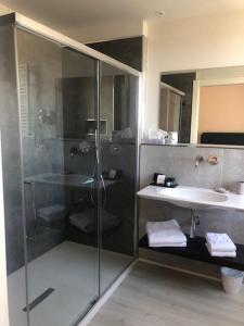 a bathroom with a shower and a sink at Hotel Bencista' in Marina di Pietrasanta