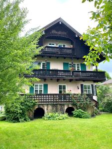 un edificio con balcone in cima a un cortile di Rosi's Ferienwohnung im Haus Sieglinde a Prien am Chiemsee