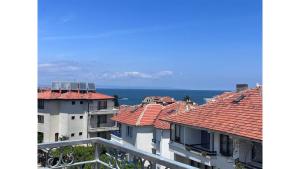 a view of buildings with the ocean in the background at Апартаменти и Студиа Алекса Созопол Apartments and Studios Alexa Sozopol in Sozopol