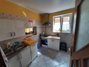 a small kitchen with a sink and a stove at Willa Elżbieta in Rewal