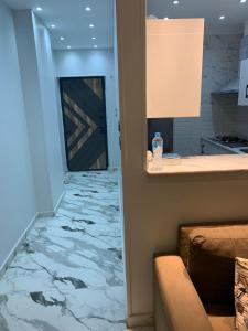 a room with a marble floor with a door and a kitchen at شقه فندقيه الترا لوكس in Asyut