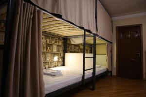 a bedroom with a bunk bed with a canopy at Sweet Sleep hostel in Yerevan
