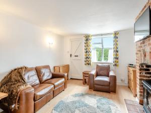 a living room with a couch and two chairs at Meadowland in Thornham Magna