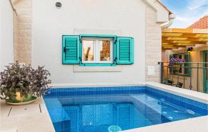 a swimming pool in a house with a window at 2 Bedroom Stunning Home In Nerezisca in Nerežišća