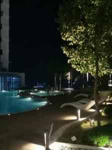 a night view of a swimming pool at night at THE SHORE KOTA KINABALU - SABAKUBA HOMESTAY (B2010) in Kota Kinabalu