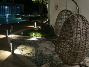 a garden at night with a swing and rocks at THE SHORE KOTA KINABALU - SABAKUBA HOMESTAY (B2010) in Kota Kinabalu