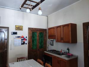 a kitchen with wooden cabinets and a sink and a door at Come a Casa - Like home in Tocco da Casauria