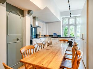 a kitchen with a wooden table and chairs at Hooke Court in Hooke