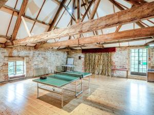 a room with a ping pong table in it at Hooke Court in Hooke
