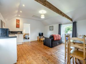 a kitchen and a living room with a table at The Coach House in New Bolingbroke