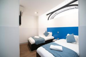 Postel nebo postele na pokoji v ubytování CiTi Hotel London Luton