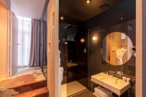 a bathroom with a sink and a mirror at Clarance Hotel Lille in Lille +37 photos