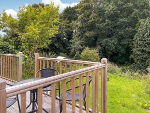 a wooden deck with a table and chairs on it at Frankland Farm in Durham