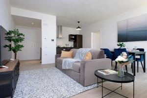 a living room with a couch and a table at Siena Hills Apartments in Siena