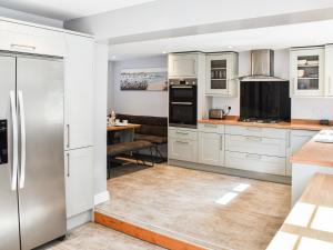 a kitchen with white cabinets and a stainless steel refrigerator at Beach Bungalow in Belton