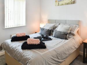 a bedroom with a large bed with two pillows at Beach Bungalow in Belton