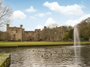 a pond in front of a castle with ducks in it at Lavender House in Barnoldswick