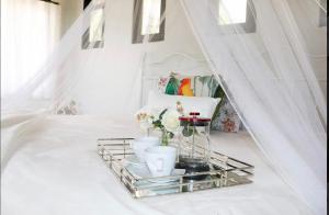 a tray with vases and flowers on a white table at Villa La Fortuna in Filipina