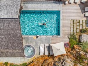 an overhead view of a person swimming in a pool at Armancette Hôtel, Chalets & Spa – The Leading Hotels of the World in Saint-Gervais-les-Bains