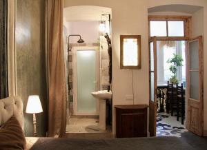 a bedroom with a bathroom with a sink and a mirror at Angels Roof Vera - boutique apartment. Wine Factory in Tbilisi City