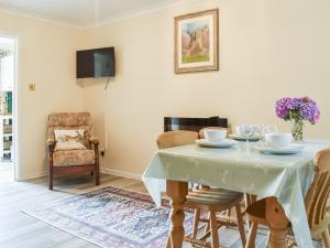 a dining room with a table and chairs at Woodlander in Dorchester