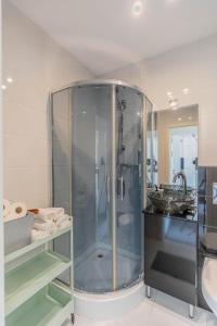 a bathroom with a glass shower and a sink at Pet’s House Warsaw in Warsaw +9 photos