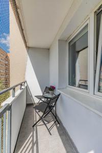 a balcony with a table and a window at Pet’s House Warsaw in Warsaw