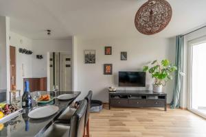 a living room with a table and a television at Pet’s House Warsaw in Warsaw