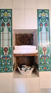 a towel rack with towels and a basket in a bathroom at La Limonaia a mare in Ponza