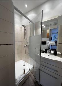 a white bathroom with a shower and a sink at Appartement - Cannes vieille ville - Le Suquet in Cannes