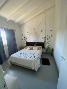 a bedroom with a large white bed in a room at Carod Espacio Serrano in Salsipuedes