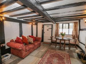 a living room with a couch and a table at Avonmede in Tewkesbury