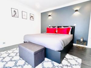 - une chambre avec un grand lit et des oreillers rouges dans l'établissement Magnifique appartement le Cannet,Cannes, Parking, Wifi, au Cannet