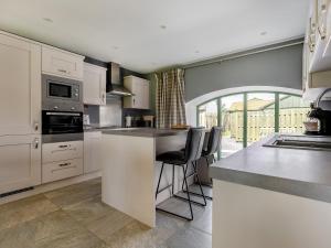 a kitchen with white cabinets and a counter top at Mayflower - Uk43632 in Grange
